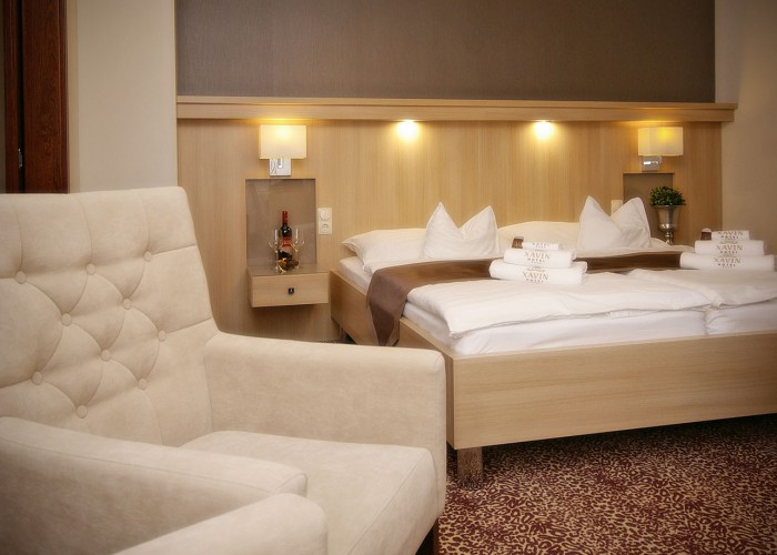 Családi lakosztály - ágy és székek, korszerű LED-es megvilágítás az ágy fejvégen